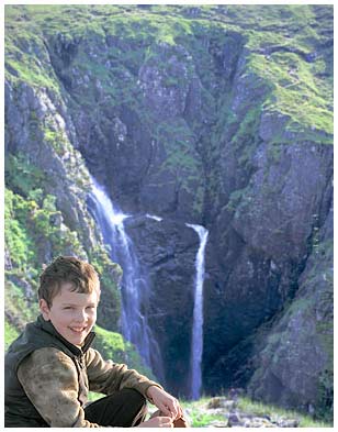 A young boy visiting the Falls of Glomach
